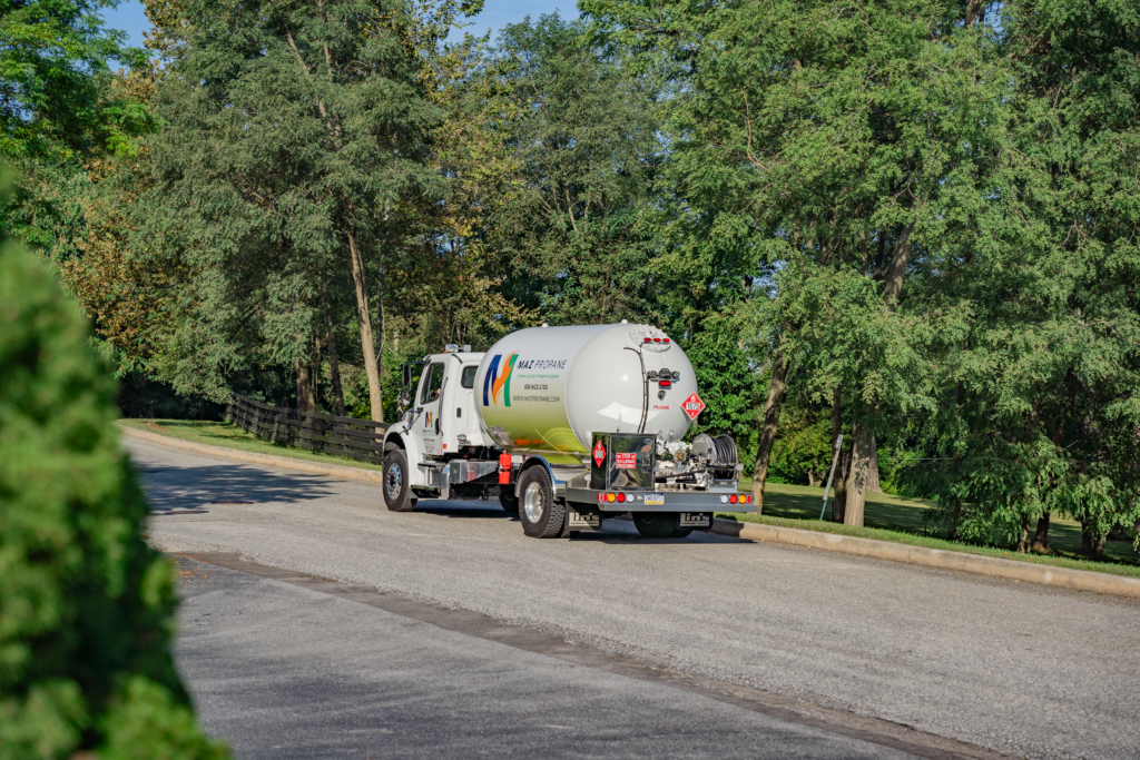 a MAZ Propane propane delivery truck parked outside a customer's home 