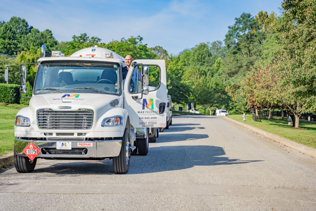 A MAZ Propane refill truck with the front door open featuring the MAZ Propane logo