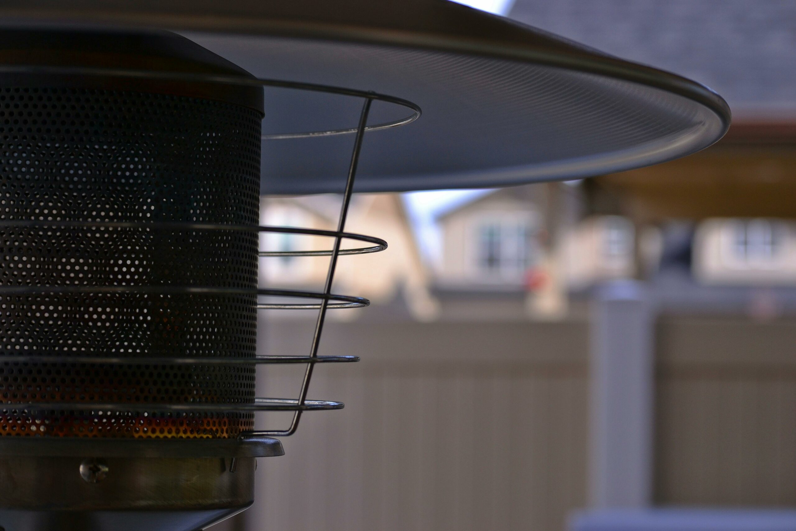 The top of an outdoor propane heater in a homeowner's backyard